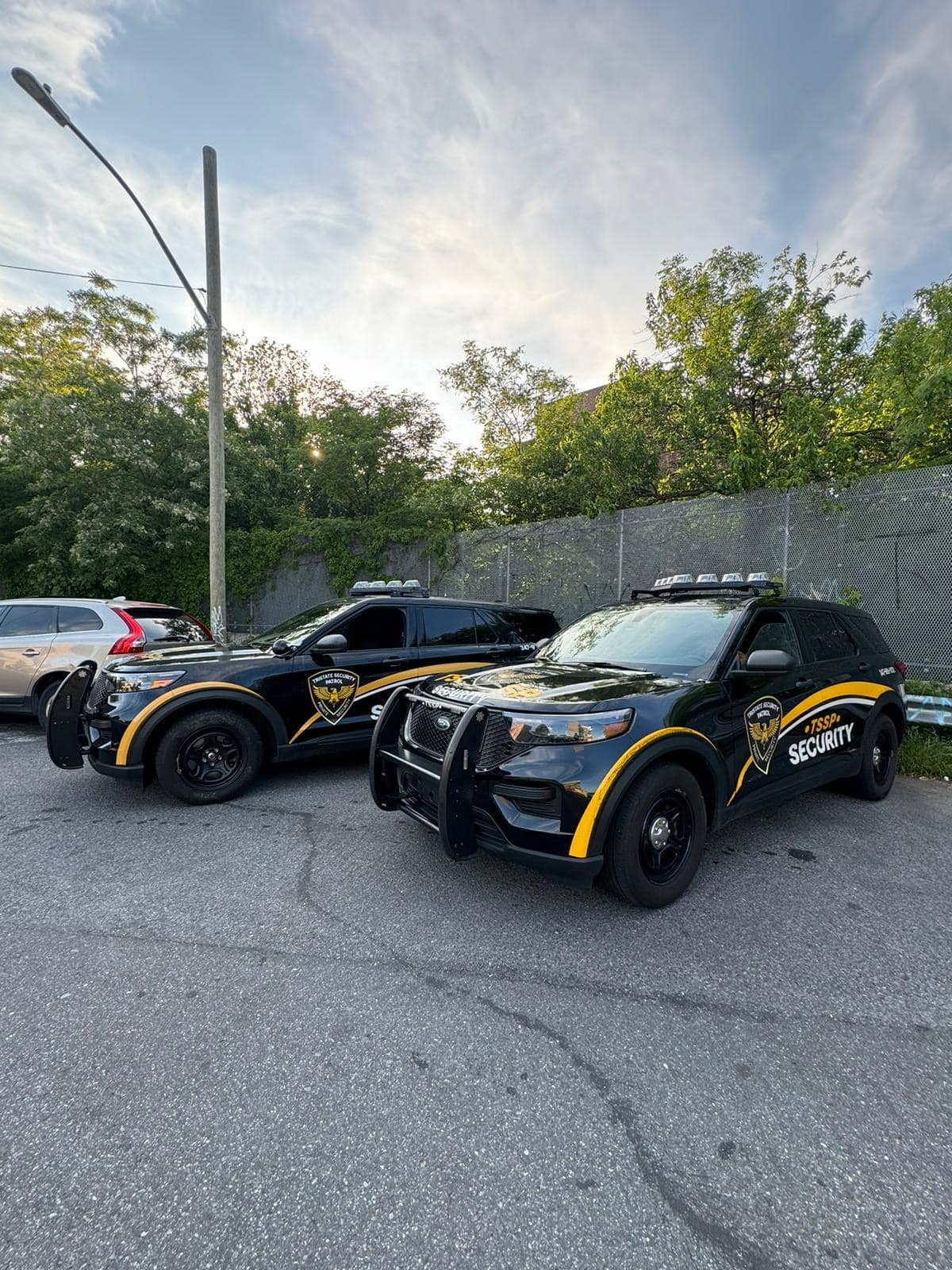 Two Tristate Security Patrol marked SUVs staged together on night patrol